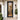 Modern black door with glass panels on a white house exterior.