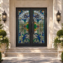Wrought iron double front doors with blue floral Tiffany-style stained glass