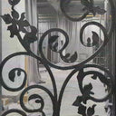 Custom wrought iron screen door with rainstorm glass