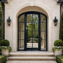 Arched top French iron entry door with sidelights and clear glass