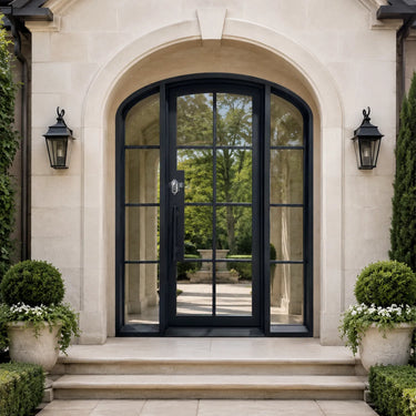 Arched top French iron entry door with sidelights and clear glass