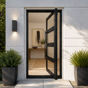 Narrow black steel pivot entry door with divided glass panels
