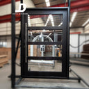 Contemporary black steel pivot door with divided glass panels