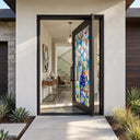 Custom wrought iron pivot front door with colorful glass patterns