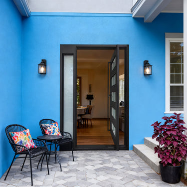 Modern black steel pivot entry door with horizontal glass panels and sidelight
