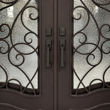 Close up of handcrafted wrought iron double door handles