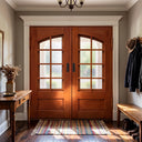 Wood look iron double front doors with arched divided glass panels and dark handles
