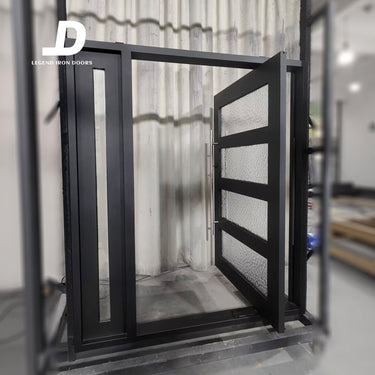 Handcrafted iron pivot door with black steel frame and decorative textured glass