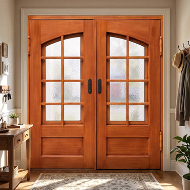 Wood grain iron double front doors with arched divided glass panels and dark handles