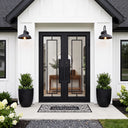 Modern double iron entry door with large clear glass panels and geometric lines