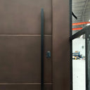 Contemporary solid panel pivot door with smart lock and long pull handle