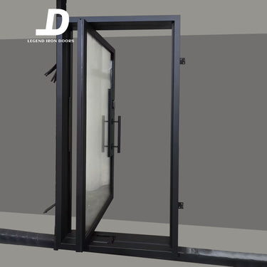 Modern glass pivot door with black frame and handle
