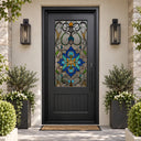 Black steel front door with blue floral stained glass and decorative vine pattern