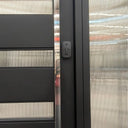 Modern pivot entry door combining large metal panels with narrow glass