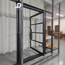 Modern pivot iron door with black steel frame and large glass panels