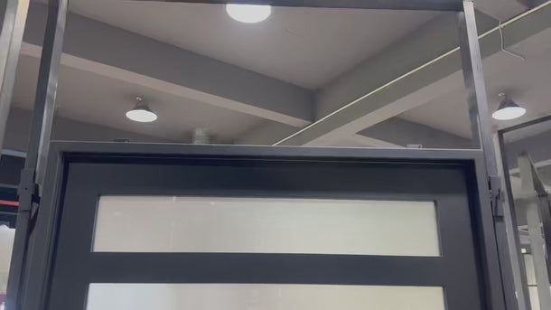 Hand made iron pivot entry door with frosted glass and black color